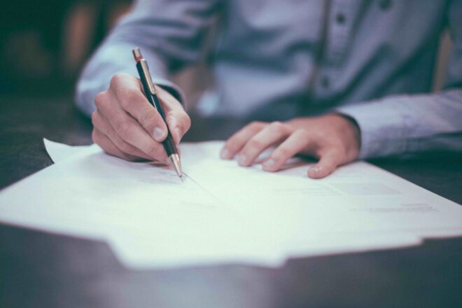 Signing a piece of paper